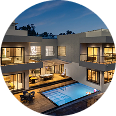 Modern luxury home with outdoor pool and evening lighting